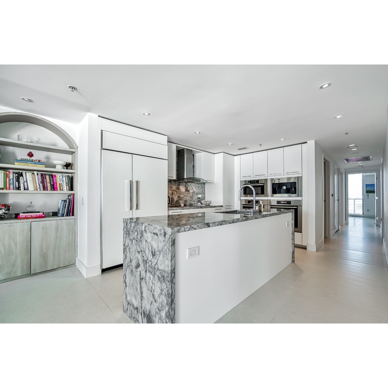 Poggenpohl White Modern Kitchen with Waterfall Island, Marble Countertops and Miele Appliances